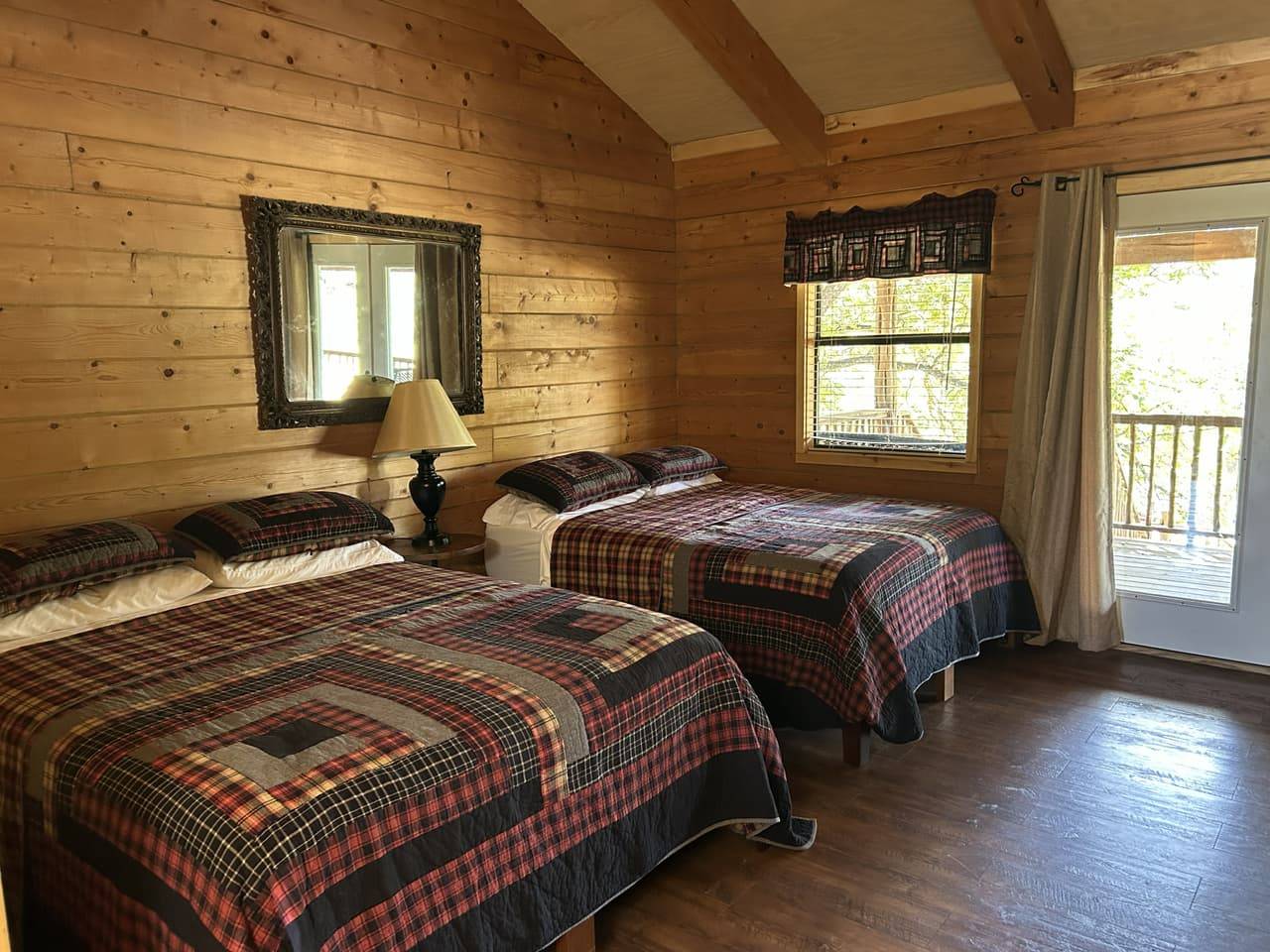 Guest room interior with two beds and rustic log-style walls