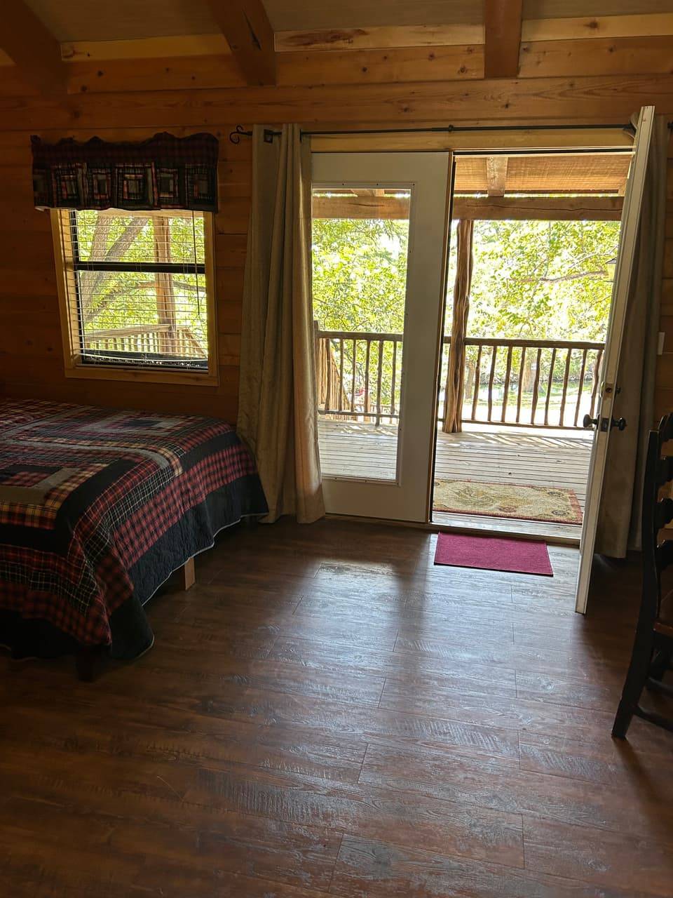 Lodge kitchenette and bathroom area at Sabinal River Lodge with light knotty-pine cabinets and vanity sink